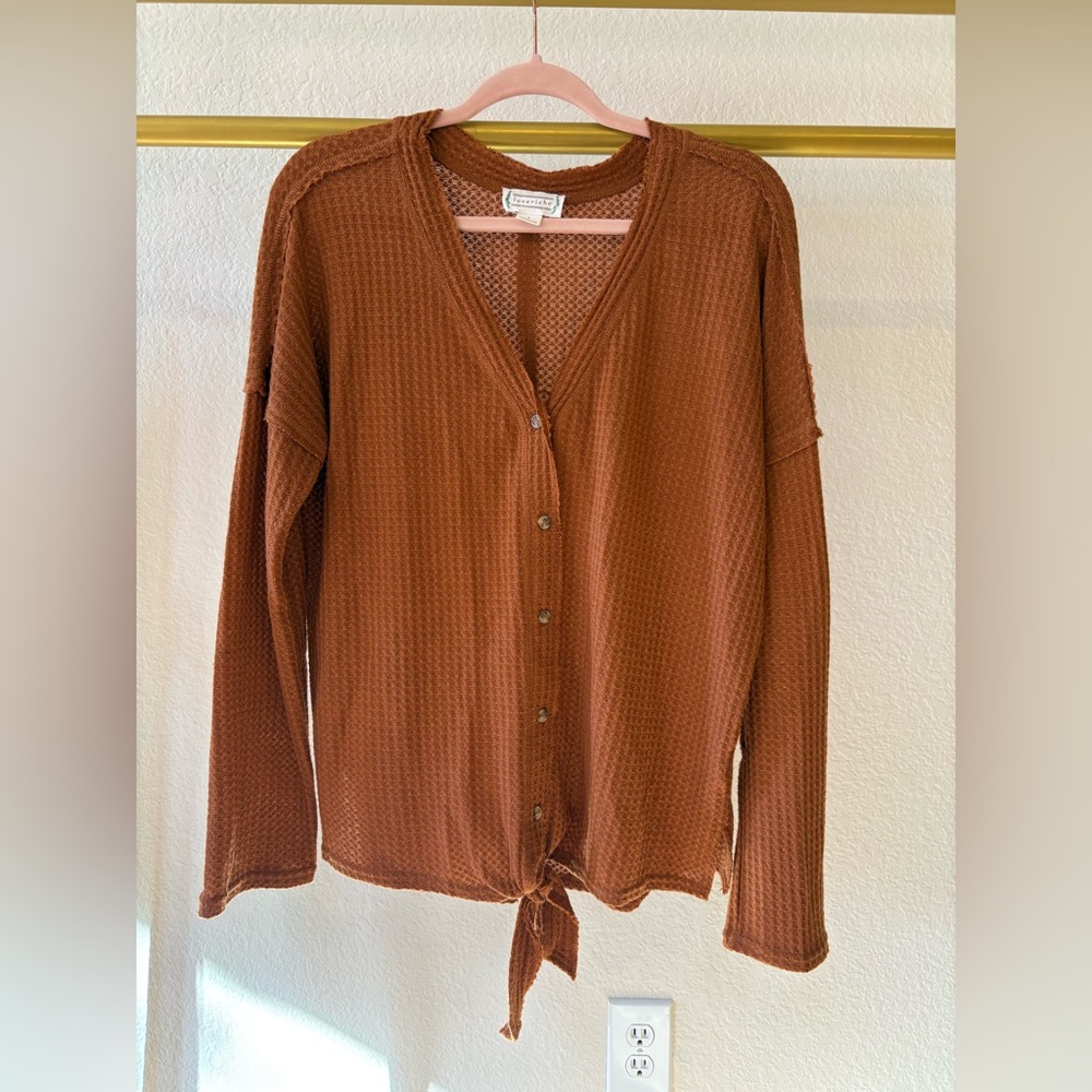 Women’s orange button up shirt with tied bow knot